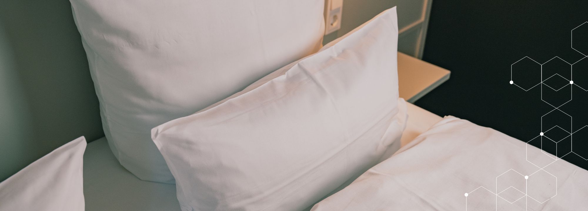 2 Kissen liegen auf einem Bett